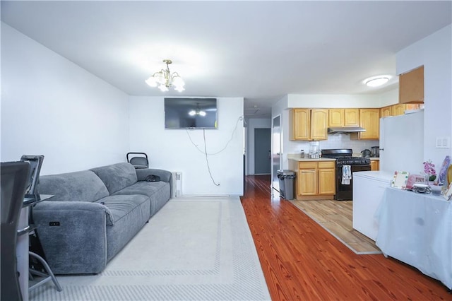 living room with hardwood / wood-style flooring and a chandelier