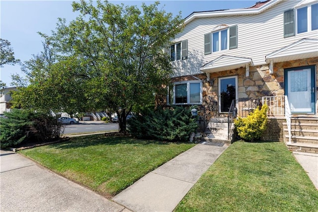 view of front of property featuring a front yard and stone siding