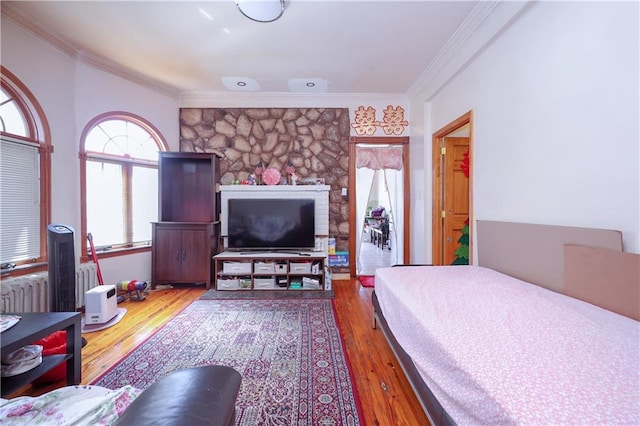 bedroom with wood-type flooring and crown molding