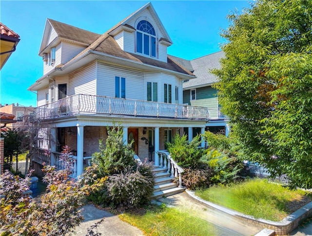 view of front of house featuring a balcony and a porch