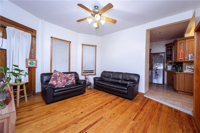 living room featuring light hardwood / wood-style flooring and ceiling fan