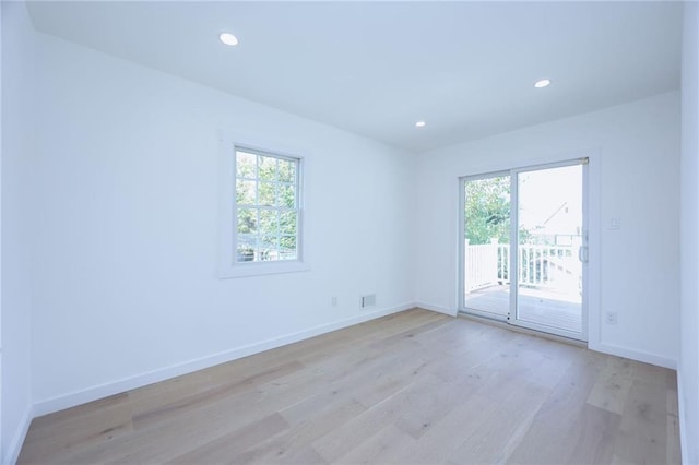 unfurnished room with light hardwood / wood-style floors and plenty of natural light