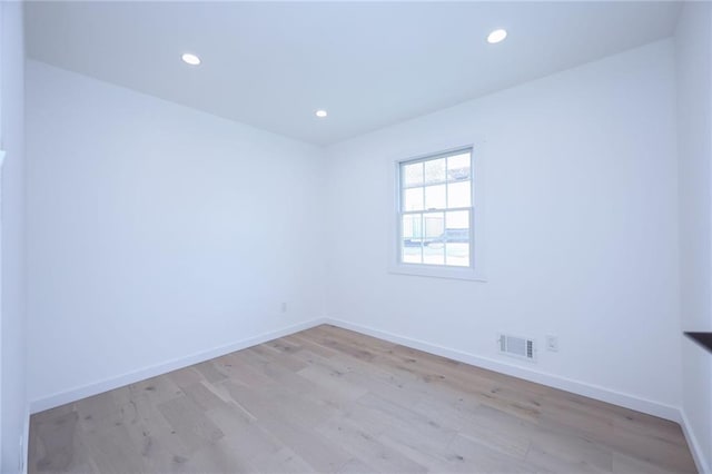 spare room with light hardwood / wood-style flooring