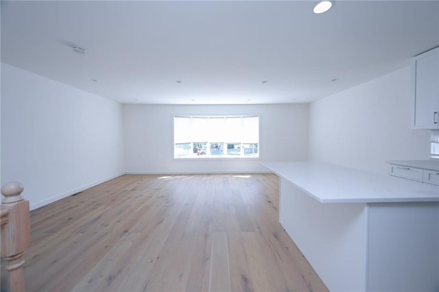 unfurnished living room featuring light hardwood / wood-style flooring