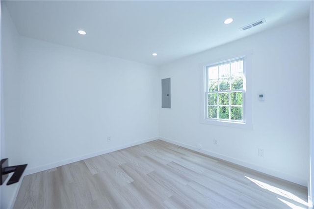 unfurnished room featuring light hardwood / wood-style floors and electric panel