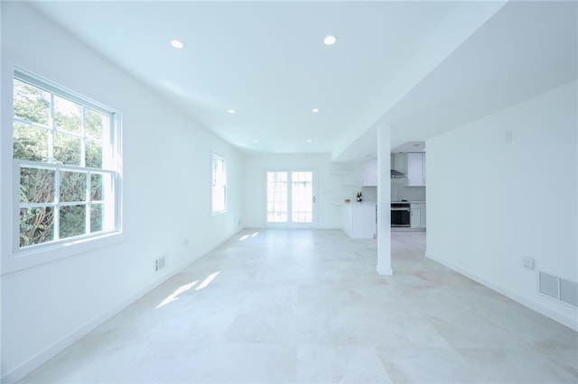 unfurnished living room featuring a healthy amount of sunlight