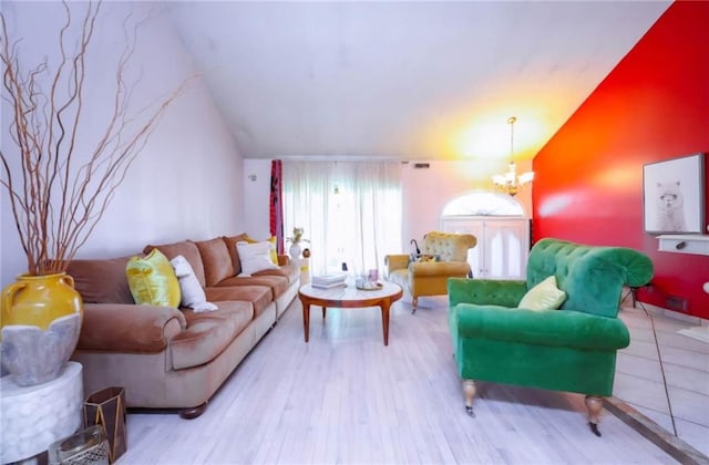 living room with vaulted ceiling, light hardwood / wood-style floors, and a chandelier