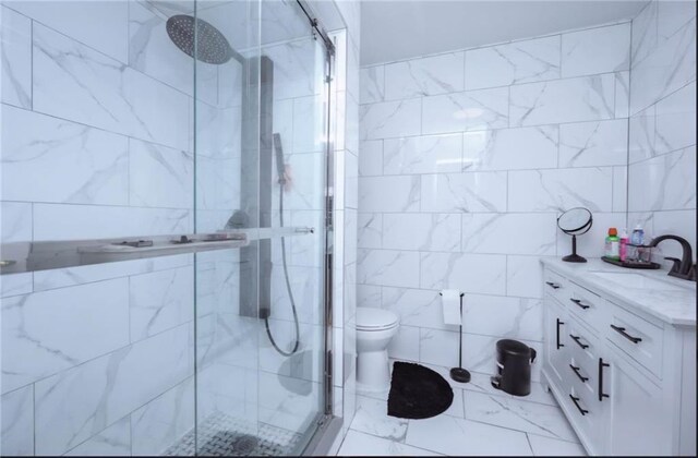 bathroom with tile walls, vanity, and a shower with door