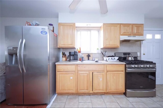 kitchen with stainless steel appliances, sink, and light brown cabinets