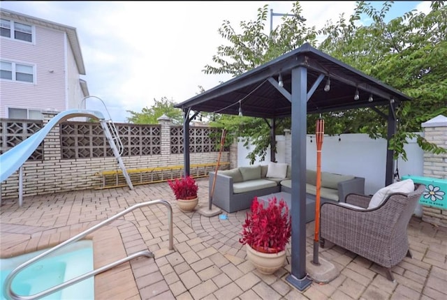 view of patio / terrace with a fenced backyard, an outdoor living space, and a gazebo