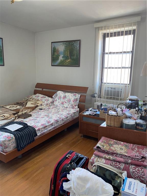 bedroom with hardwood / wood-style flooring