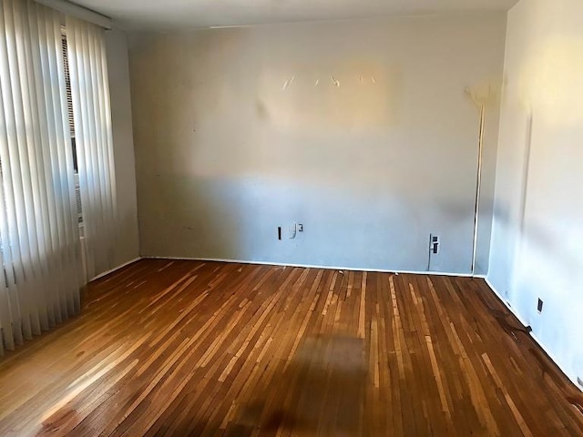 spare room featuring dark hardwood / wood-style flooring