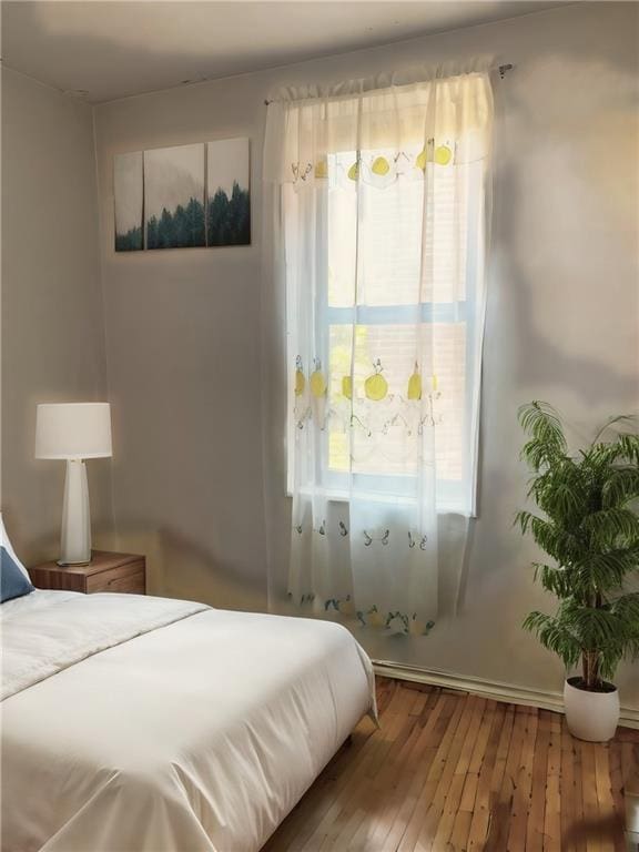 bedroom featuring hardwood / wood-style floors and multiple windows