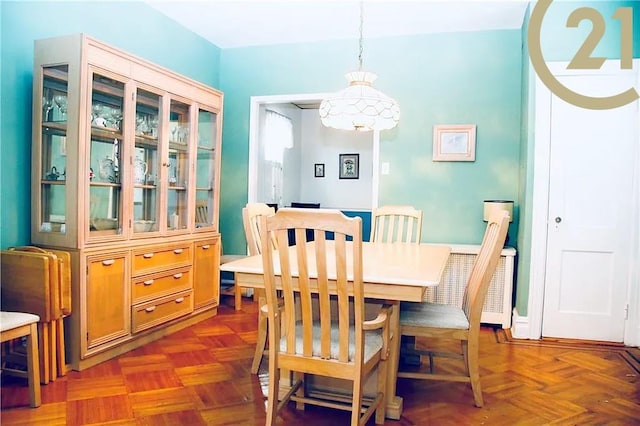 dining room featuring dark parquet floors