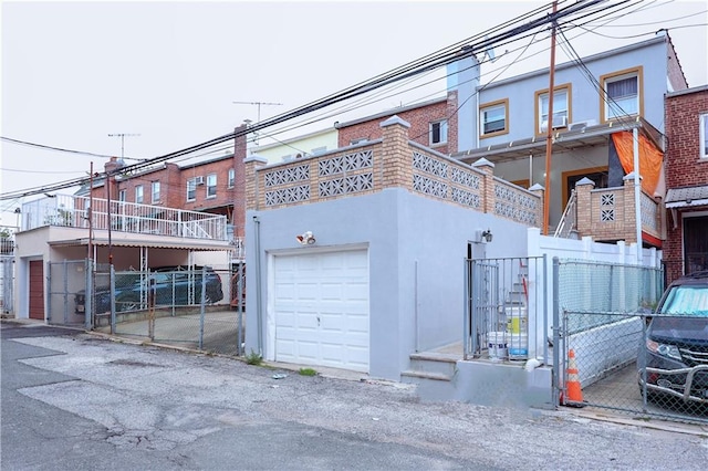 garage featuring a gate and fence