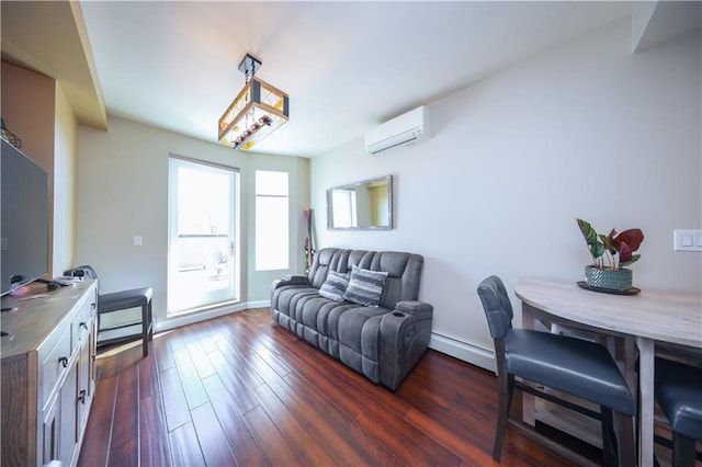 living area featuring baseboard heating, dark wood-style flooring, a wall unit AC, and baseboards