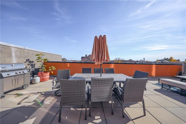 view of patio with outdoor dining area and a grill