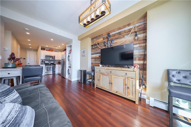 living area with a baseboard heating unit, baseboards, dark wood finished floors, and recessed lighting