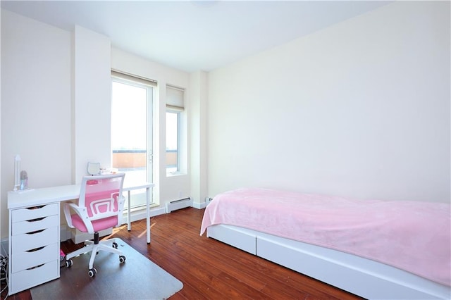 bedroom featuring baseboard heating and dark hardwood / wood-style flooring