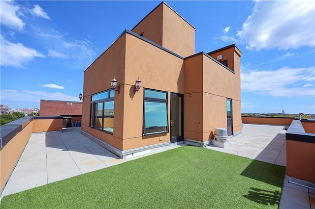 rear view of property featuring a patio area and a yard