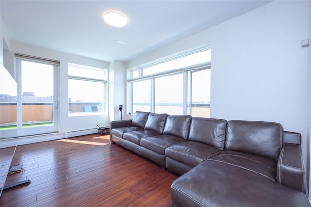 living room with a water view, dark hardwood / wood-style floors, and a baseboard heating unit