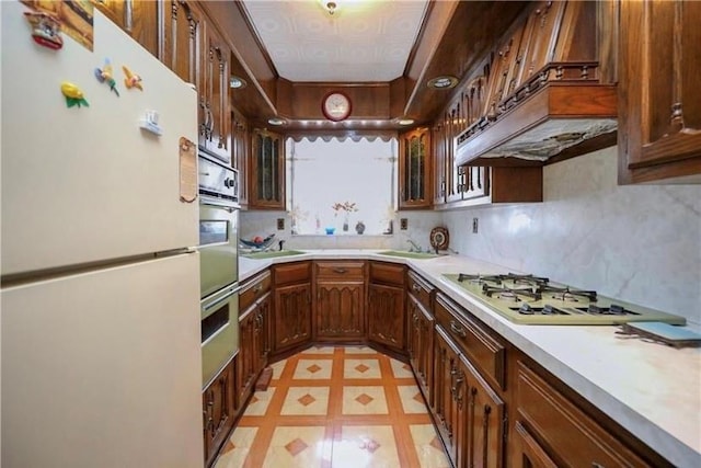 kitchen with decorative backsplash and white appliances