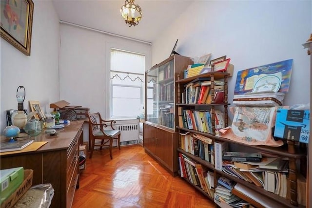 interior space featuring a notable chandelier, parquet flooring, and radiator