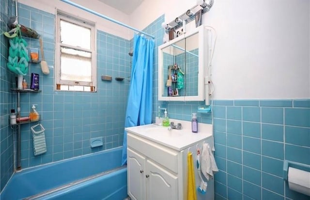 full bath with shower / bath combination with curtain, tile walls, and vanity