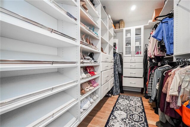 spacious closet with light hardwood / wood-style floors