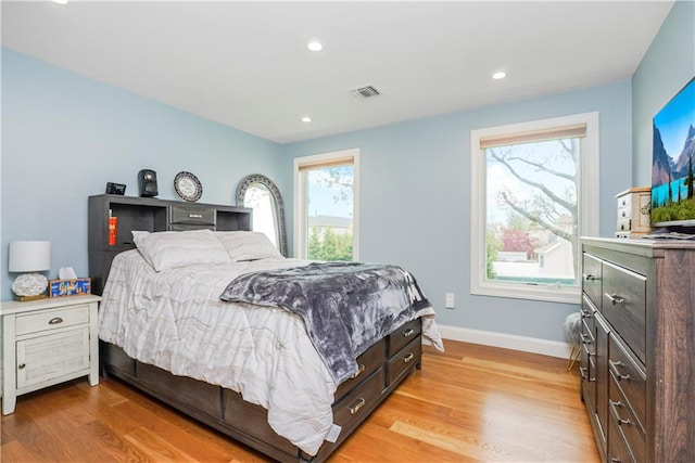 bedroom with recessed lighting, visible vents, baseboards, and light wood finished floors