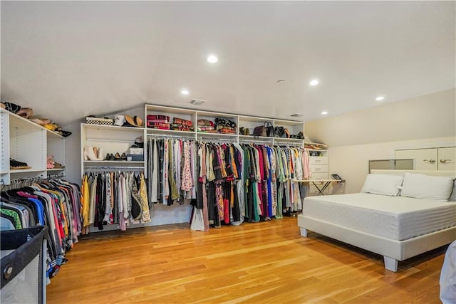 bedroom featuring lofted ceiling, recessed lighting, and wood finished floors