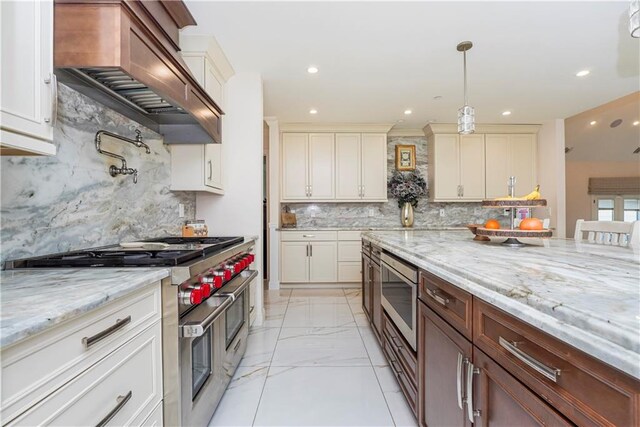 kitchen with tasteful backsplash, pendant lighting, stainless steel appliances, and custom range hood