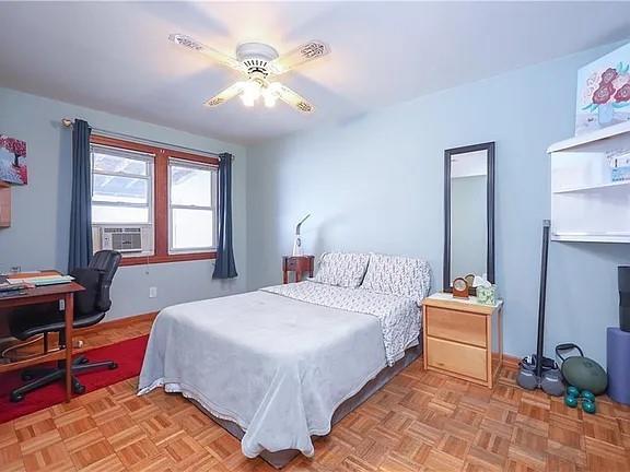 bedroom with cooling unit and ceiling fan