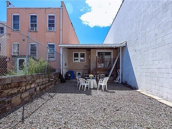 rear view of property with a patio area and fence