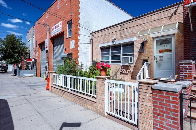 exterior space featuring a fenced front yard and cooling unit