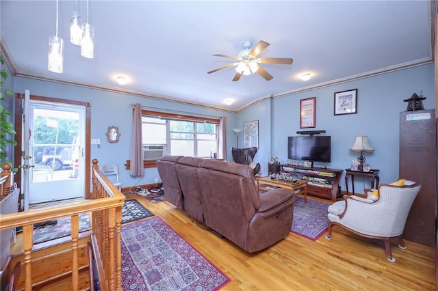 living area with crown molding, plenty of natural light, and light wood finished floors