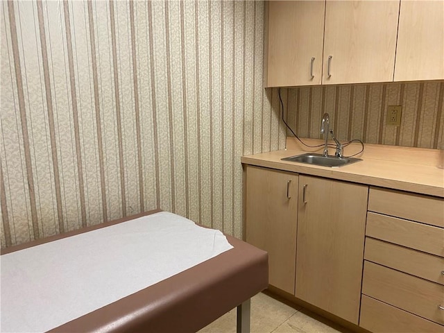 interior space with sink, light brown cabinets, and light tile patterned floors