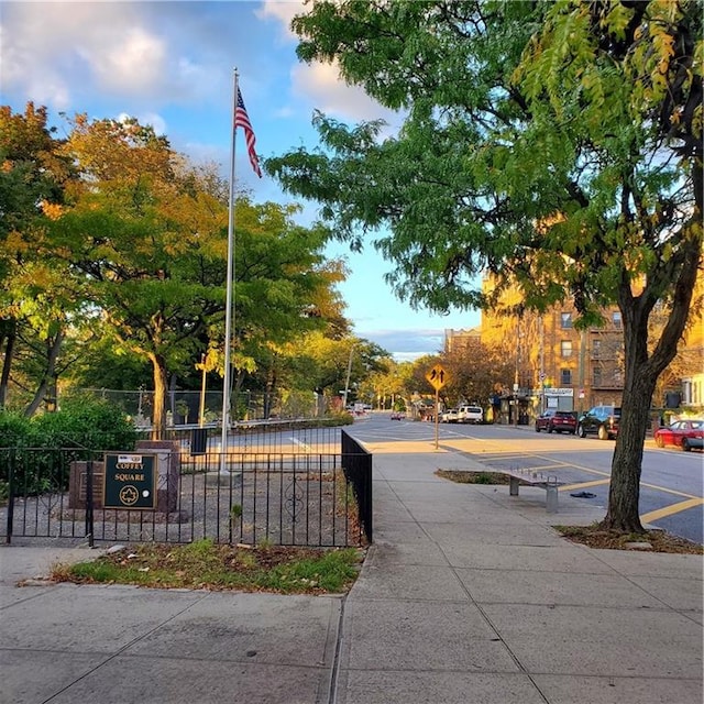 view of home's community featuring fence