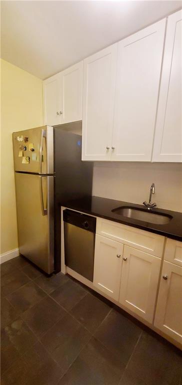 kitchen featuring sink, white cabinets, and stainless steel appliances