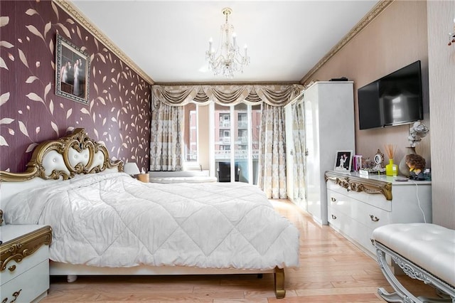 bedroom featuring light wood finished floors, an inviting chandelier, ornamental molding, access to outside, and wallpapered walls