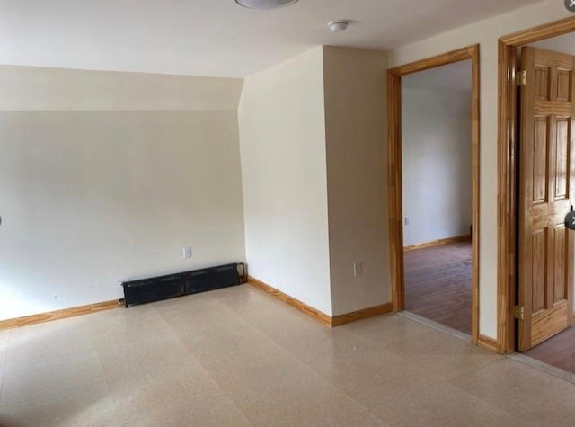 unfurnished room featuring baseboards and tile patterned floors