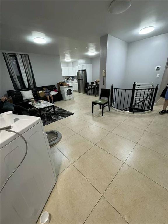 interior space with washer / clothes dryer and light tile patterned floors