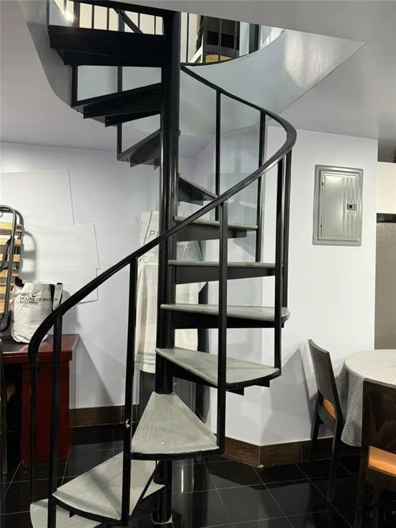 stairway with tile patterned flooring and electric panel