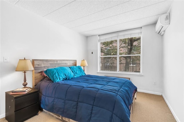 bedroom with an AC wall unit and light colored carpet