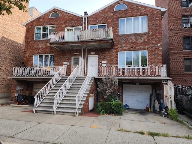 multi unit property with a balcony, cooling unit, and a garage