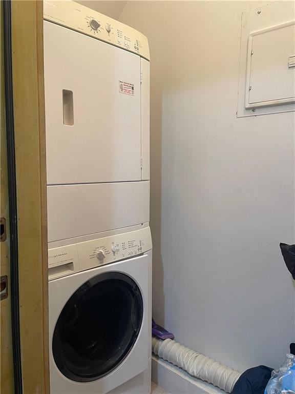 washroom featuring stacked washer / drying machine