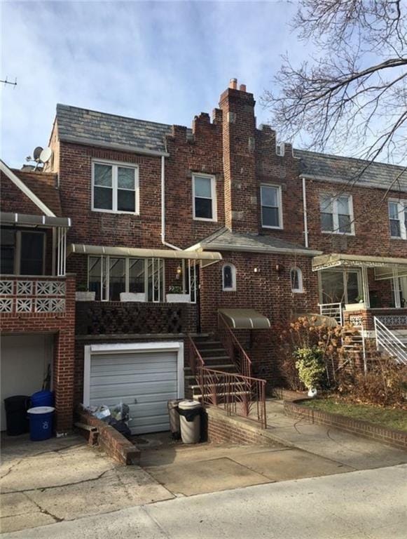 2216 E 26th St, Brooklyn, NY 11229 - view of property with concrete driveway, brick siding, and an attached garage