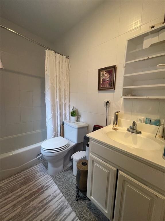 full bathroom featuring vanity, tile walls, shower / bath combo with shower curtain, and toilet