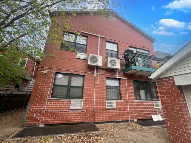 view of side of property featuring a balcony and ac unit