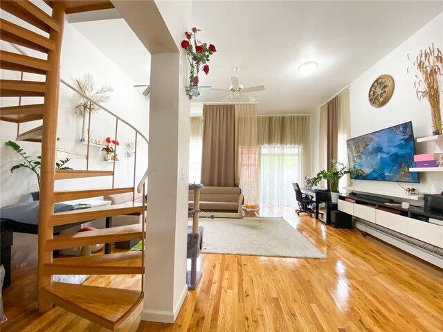 interior space with ceiling fan and hardwood / wood-style flooring